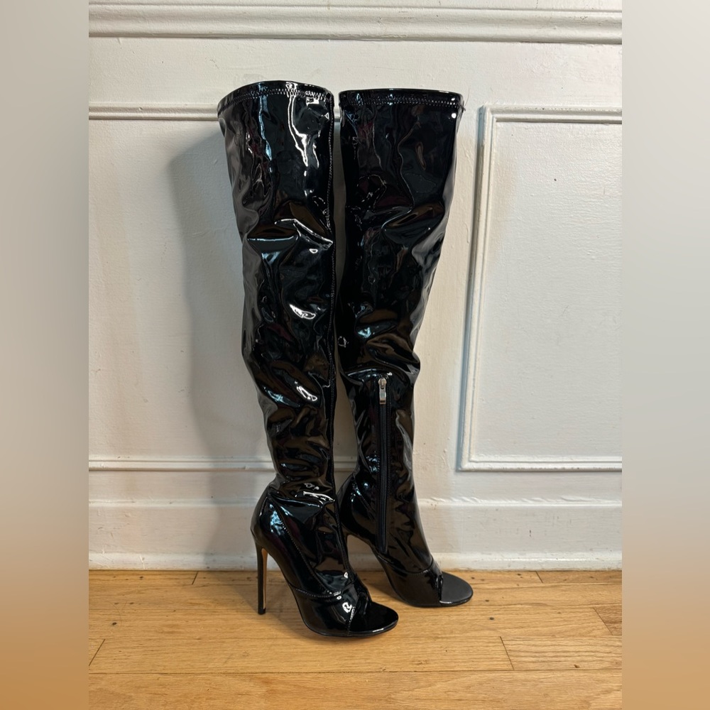 Knee high shiny black pleather boots.